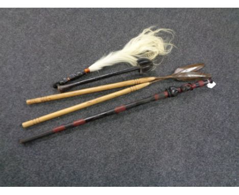 A tribal walking stick together with two wooden spears, a club and a fly swish. 