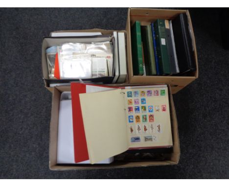 Three boxes containing a large quantity of world stamps and first day covers in albums and folders.  
