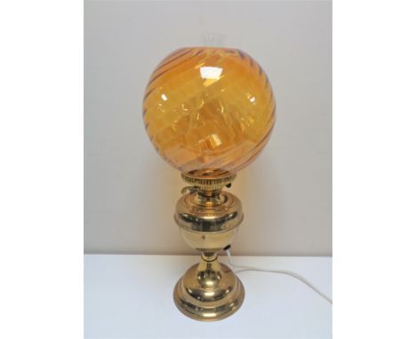 A brass Duplex oil lamp with amber glass shade and chimney (converted)