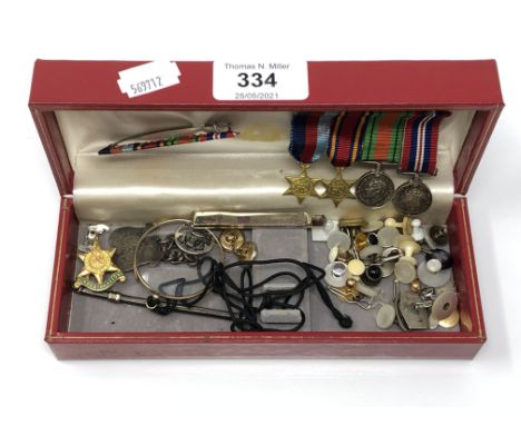 A box containing silver swizzle stick (a/f), miniature WWII medals, monocle, dress studs etc