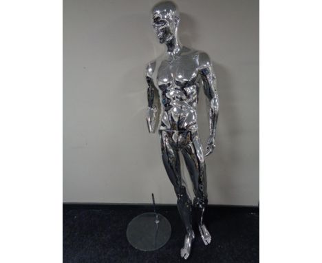A male shop mannequin on glass stand (silver, missing hand)
