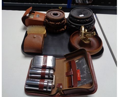 A tray of wooden oriental style stands, 1970's teak and brass nut cracker bowl, leather cased brushes, travel set etc 