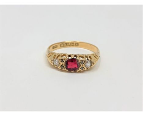 An 18ct gold diamond and garnet ring, size O CONDITION REPORT: 2.6g