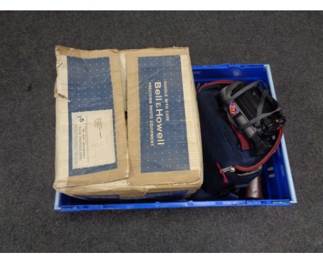 A crate containing a boxed Bell and Howell vintage projector together with a Samsung video camera, a Quarz cine camera and on