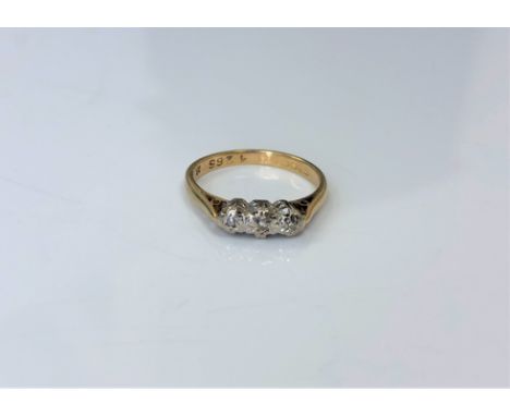 An 18ct gold three stone diamond ring, size K.  CONDITION REPORT: 2.4g