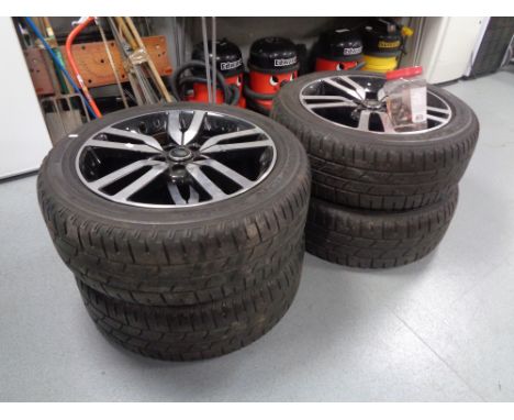 A set of four 20'' Land Rover alloy wheels with Pirelli 255/50R20109Y tyres, together with a tub containing wheel bolts.   