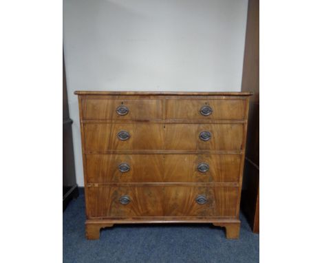 A George III style mahogany five drawer chest on bracket feet