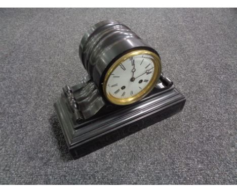 A late nineteenth century black slate mantel clock with circular enamel dial 