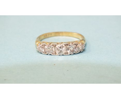 A Victorian five stone diamond ring claw set five graduated old brilliant cut diamonds in 18ct gold scrolling mount, size K, 