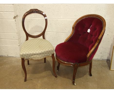 A Victorian walnut salon chair with upholstered seat, button back and carved front legs with casters, and a Victorian balloon