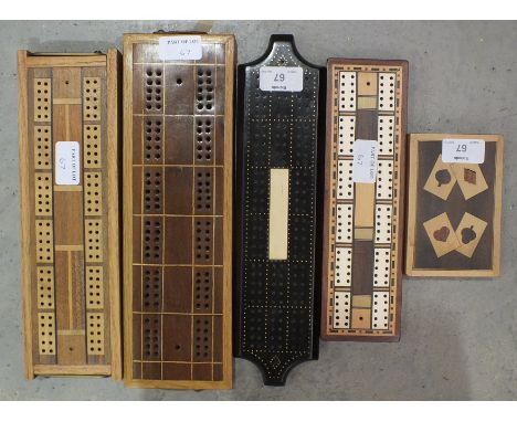 Four Modern craftsman-made wood cribbage boards and a plain card box.