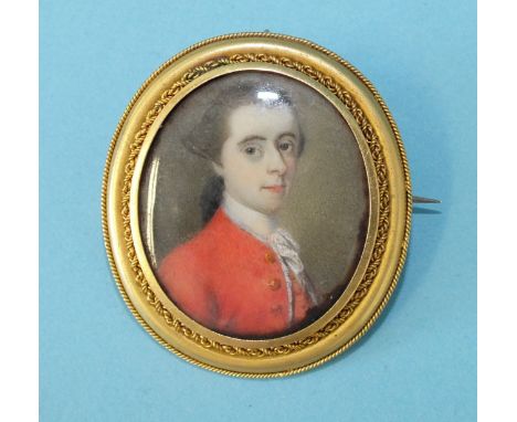 A Georgian yellow metal oval brooch inset a portrait miniature of a young gentleman in a red coat, locket back, 39mm x 35mm.