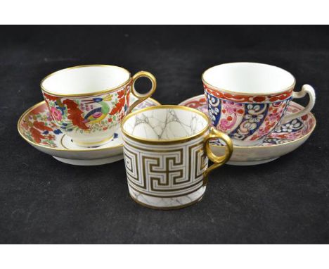 A Worcester porcelain tea cup and saucer in blue and red floral spiral pattern, a floral pattern cup and saucer (both bearing