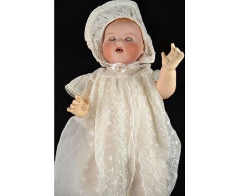 An Armand Marseille bisque headed doll, sleepy blue eyes, open mouth with teeth, no.351/9K, composition jointed body, dressed
