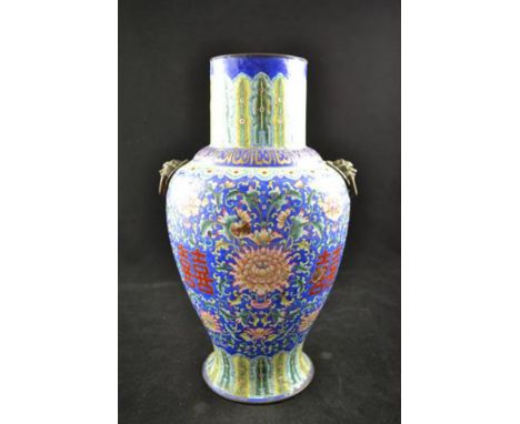 A Chinese Canton enamel baluster vase, lappets to top and base, dragon handles, decorated with chrysanthemums, damage to the 