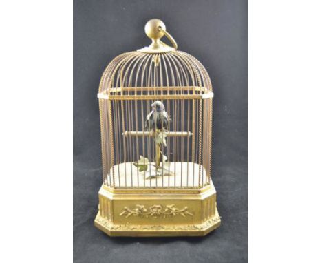 A 19th/early 20th Century singing bird automaton in gilt wirework cage, clockwork movement to base, bearing label "Whitchurch