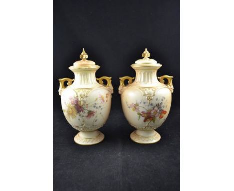 A pair of Royal Worcester blush ivory floral painted two handled vases and covers, printed mark to base with date code for 18