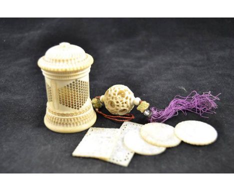 A pierced ivory cylindrical pot and cover - H7.5cm, five mother of pearl counters, together with carved ivory puzzle ball pen