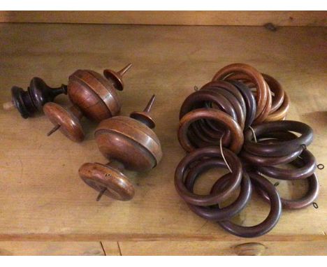 A group of wooden curtain rings (each internal d.7.5cm) and two fruitwood finials and a single finial (a lot)