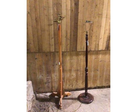 A modern mahogany fluted turned wood floor lamp and a stained pine upright triangular stepped floor  lamp raised on shaped mo