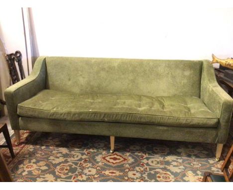 A large contemporary sofa, in olive green upholstery with single buttoned seat cushion, on tapering square supports with cast