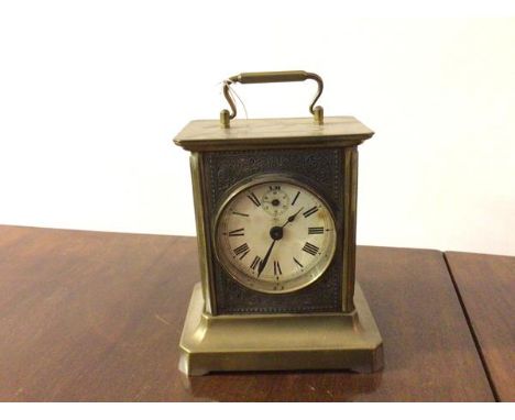 A carriage clock, c.1890, the front panel with circular dial and roman numerals, within a blind fretwork metallic panel with 