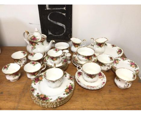 A Royal Albert Old Country Rose pattern tea service with six teacups and saucers, teapot (19cm), two milk jugs, two sugar bow