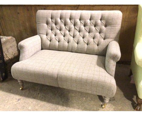 An  Anta style contemporary two seater sofa in soft grey tweed upholstery with button back with scroll arms, on turned front 