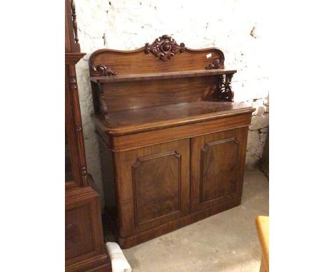 A Victorian mahogany chiffonier, the back with carved crest above a ledge supported by pierced supports, above a moulded top,