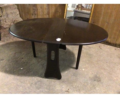 An Ercol elm drop leaf occasional table, the oval top with two drop leaves, on gateleg supports, stamped Ercol to side (48cm 