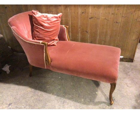 A late 19thc/early 20thc  French chair back daybed with button back in pink velvet and moulded arms, raised on cabriole suppo