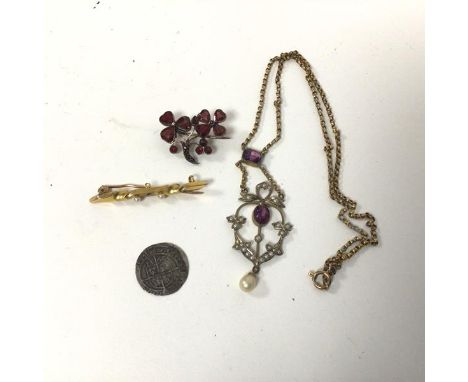 A 15ct gold bar brooch with two seed pearls, one missing (1.94g), a white metal brooch set red stones, a yellow metal necklac