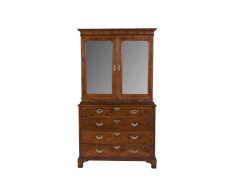 A FINE GEORGE I WALNUT CABINET SECRETAIRE CHEST, the plain moulded cornice above twin mirrored panel doors, enclosing an arra