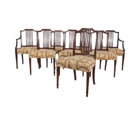 A SET OF EIGHT EDWARDIAN MAHOGANY STICK BACK DINING CHAIRS, the channelled frame with upholstered seats and raised on turned 