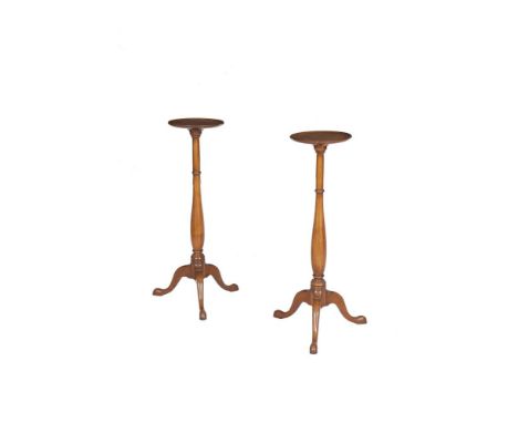 A PAIR OF MAHOGANY STANDS, in Georgian style, on tripod bases. Each 90cm high x 26cm diameter
