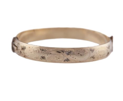 A BANGLE BRACELETThe bangle with engraved motifs, stamped 9K gold, (possibly gold plated)