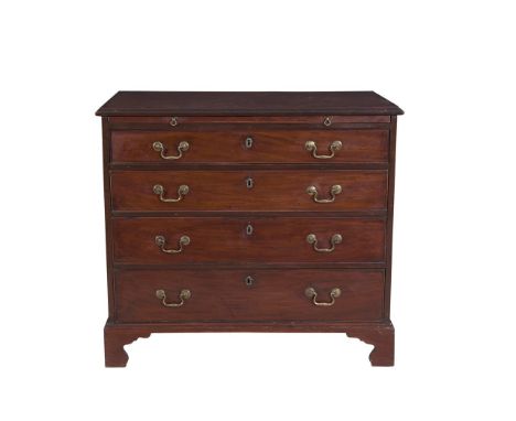 A GEORGE III MAHOGANY RECTANGULAR CHEST of four long drawers with pull out brushing slide, brass fittings raised on bracket f