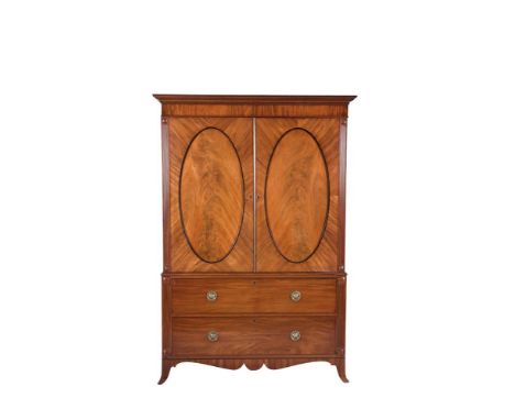 A LATE REGENCY MAHOGANY TWIN DOOR GENTLEMAN'S WARDROBE, with plain moulded cornice above twin inset oval panelled doors on a 