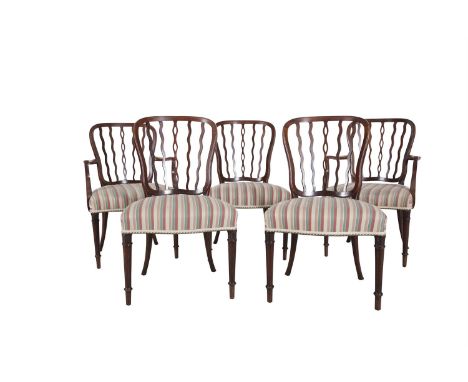 A SET OF SIX MAHOGANY FRAMED WAVE STICK BACK DINING CHAIRS, the curved backs raised above wide bowfronted upholstered seats a