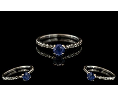 18ct Sapphire &amp; Diamond Ring, central sapphire set between brilliant cut diamonds.  Fully hallmarked.  Ring size P.