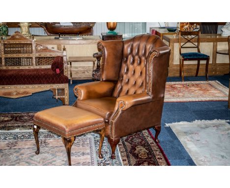 Leather Wing Back Chesterfield Chair &amp; Matching Footstool, buttoned back style with stud trim, light brown colour, ball f