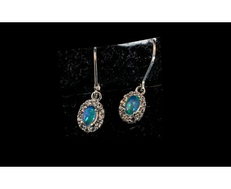 Opal Halo Set Drop Earrings, 1.5cts of oval cut opals, framed with halos of natural white zircons, suspended from secure rhod