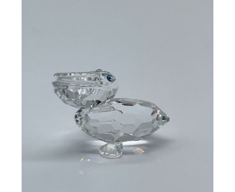 This retired Swarovski Crystal Pelican Figurine, part of the renowned "Feathered Friends" collection, is a stunning piece des