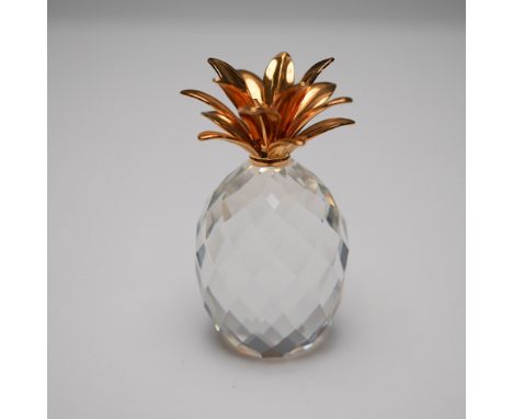 This Swarovski Pineapple Gold Small figurine showcases an intricately faceted clear crystal body crowned with radiant gold-to
