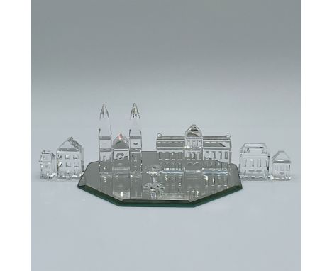 A stunning 7-piece Swarovski crystal set featuring intricately designed city buildings, a stool, and the tallest piece—a cath