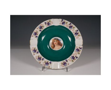 A beautifully crafted porcelain plate by Cico, featuring a vibrant floral border with purple violets and a striking hand-pain