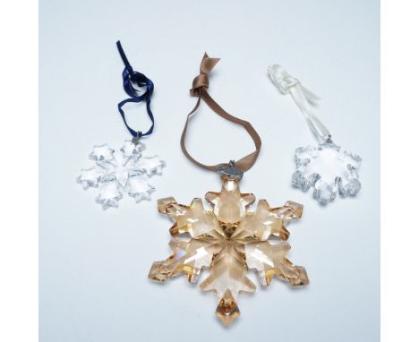 A dazzling trio of Swarovski Christmas ornaments, each showcasing the brand’s renowned crystal artistry. Included is the 2004