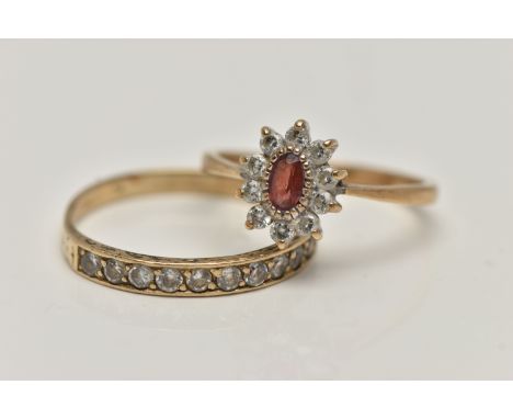 TWO YELLOW METAL GEM SET RINGS, the first an oval cluster set with an oval cut garnet and colourless cubic zirconia, pinched 