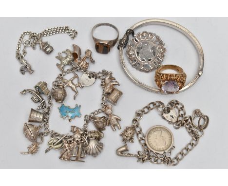 A SELECTION OF SILVER AND WHITE METAL JEWELLERY, to include three charm bracelets, a hinged bangle, two gem set rings and a s