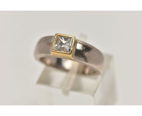 A YELLOW AND WHITE METAL SINGLE STONE DIAMOND RING, princess cut diamond collet set in a yellow metal mount, to a polished wh